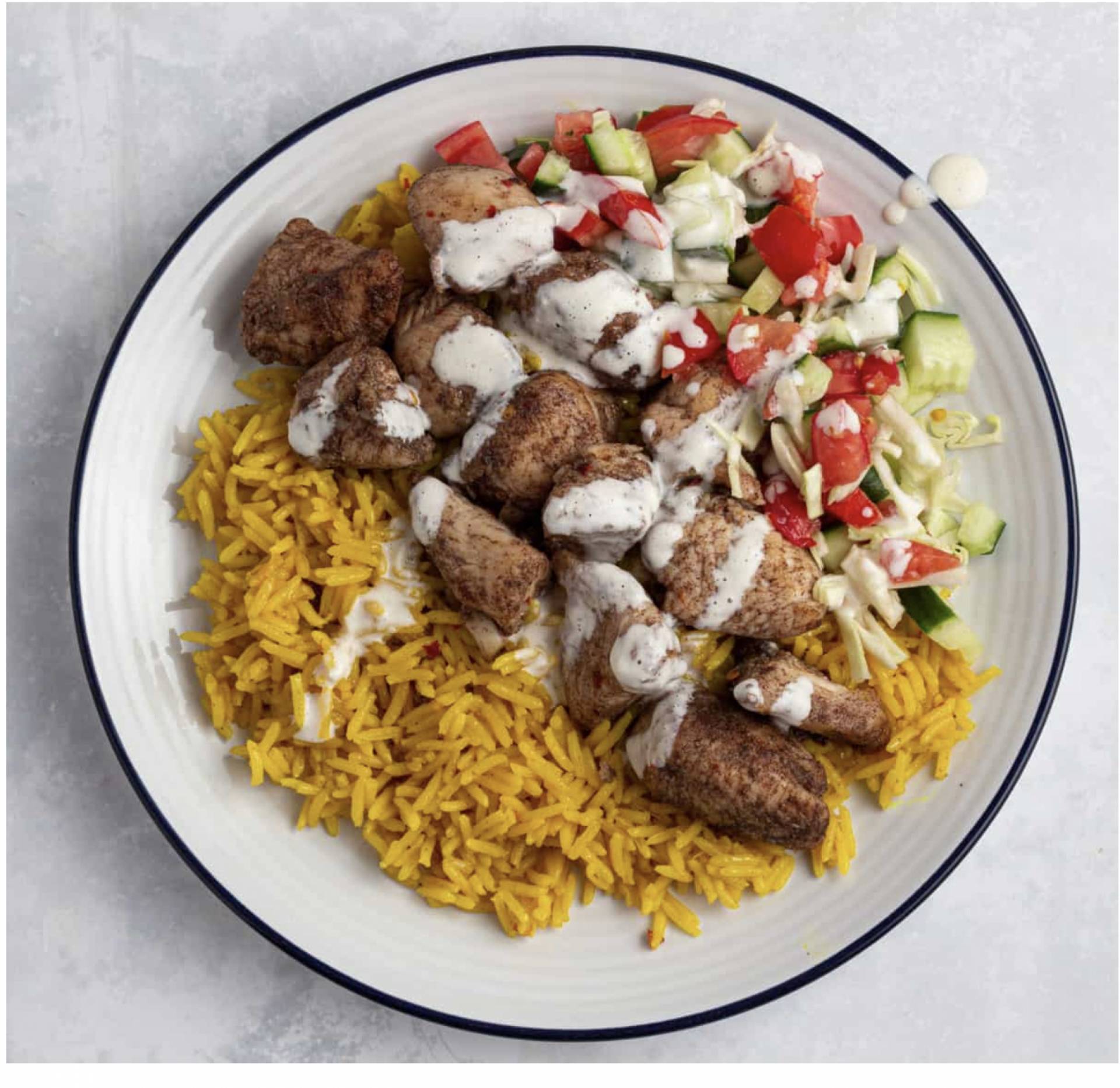 Middle Eastern Spiced Chicken Shawarma with Saffron Rice, Roasted Cauliflower, Cucumber-Tomato Salad, and Tzatziki